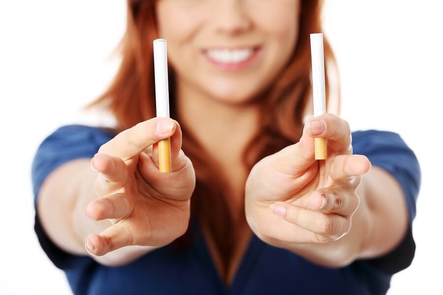 Teen girl holding one cigarette and one e cigarette