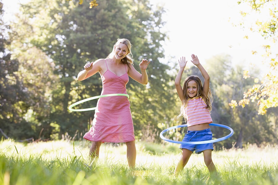 Fun Family Fitness, Mom and girl hula hooping outside for exercise