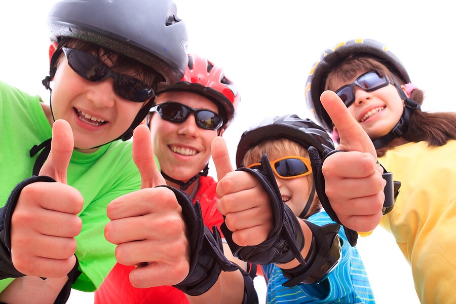 Fun Family Fitness, Four kids in bike helmets and pads exercising together