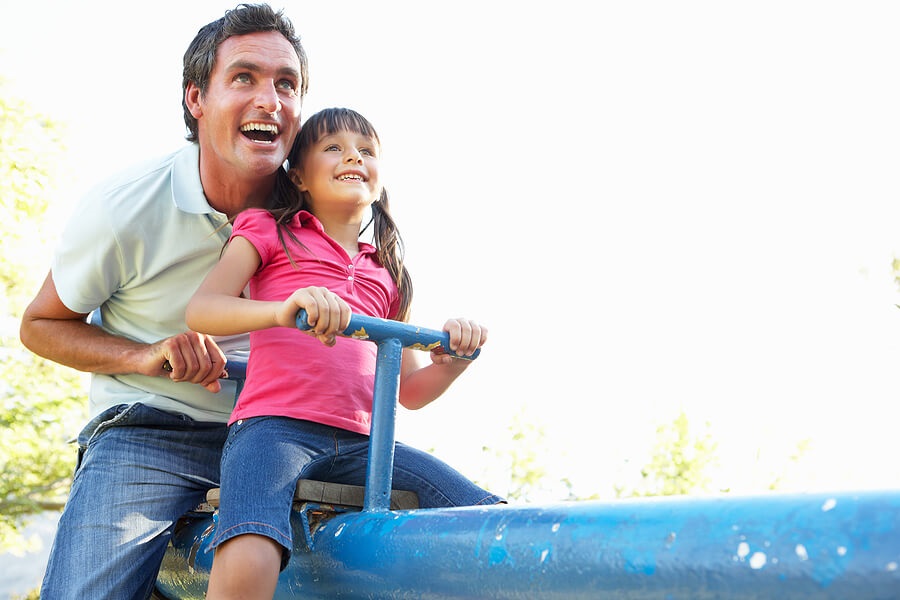 Fun Family Fitness, Father and daughter on seesaw at playground