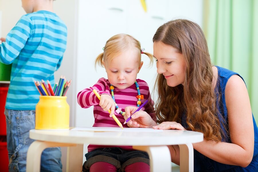 Young girl coloring at daycare