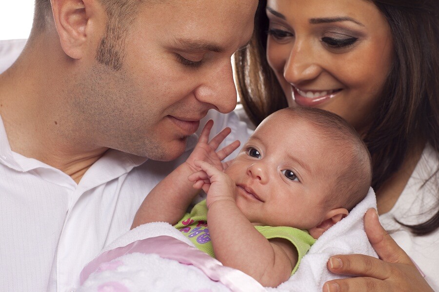 Happy young couple with baby