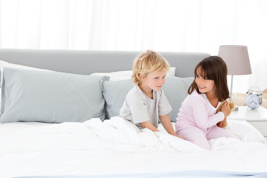 Brother and sister in parents bed