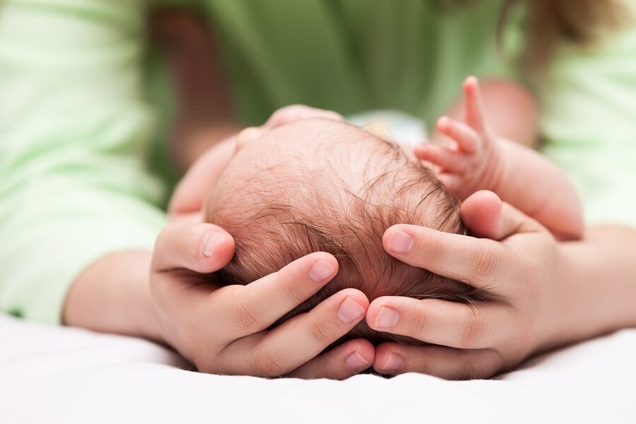 Mom cradling newborn baby