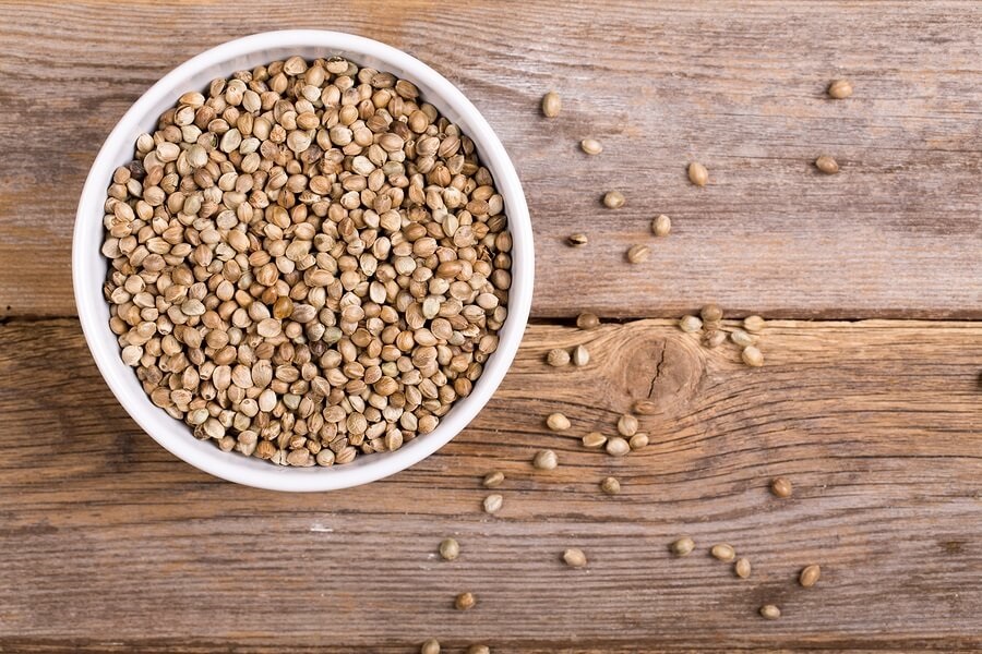 Bowl of hemp seeds on wooden table