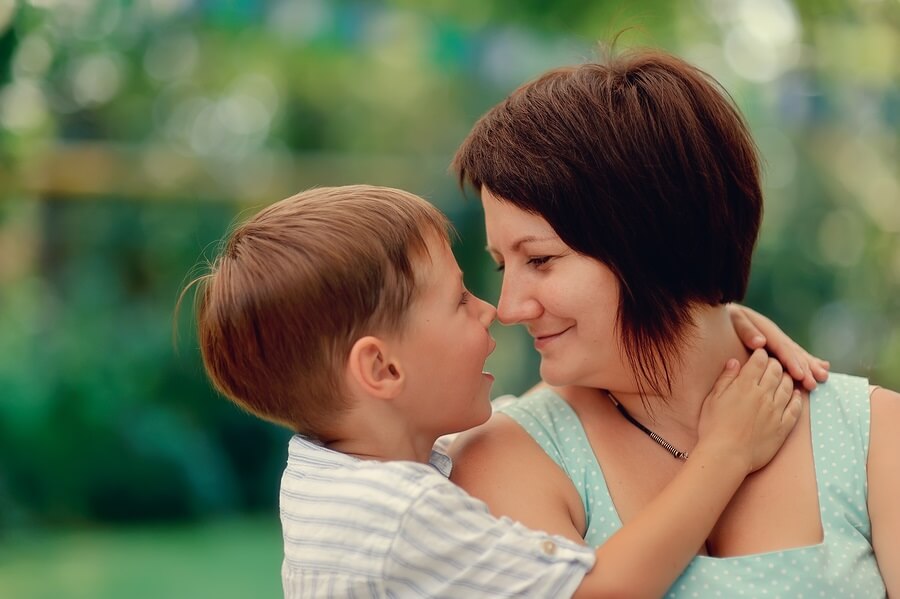 Happy mother and young son hugging