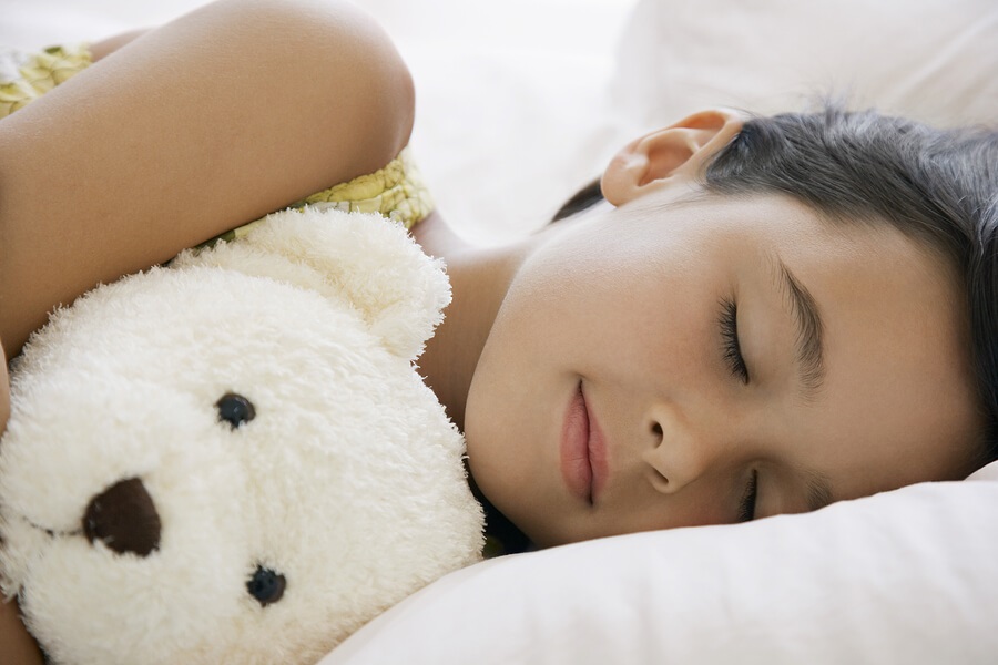 girl sleeping with teddy bear