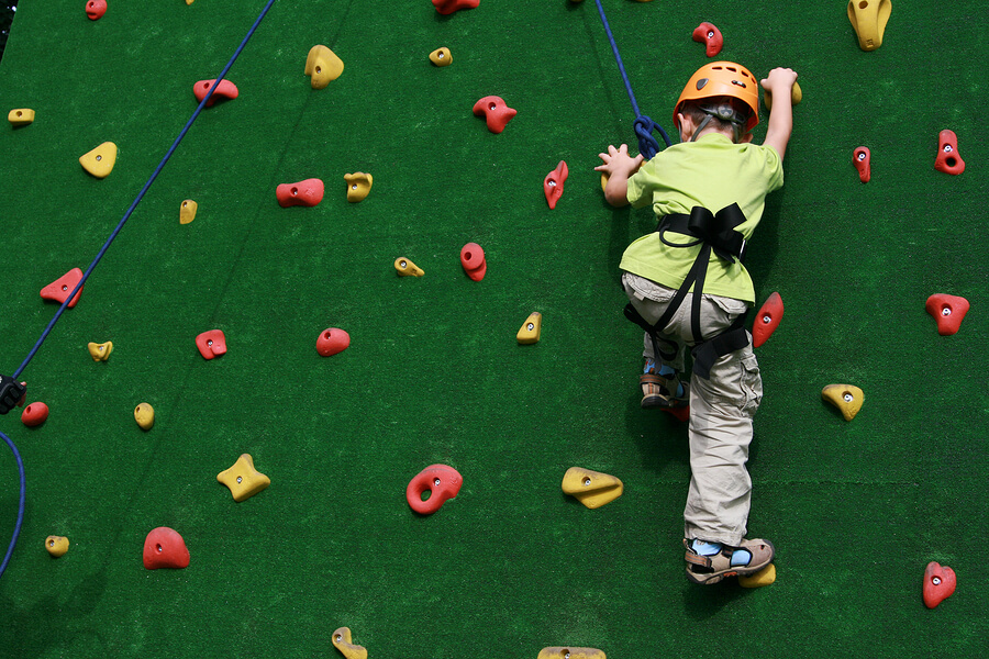 child climbing rock wall