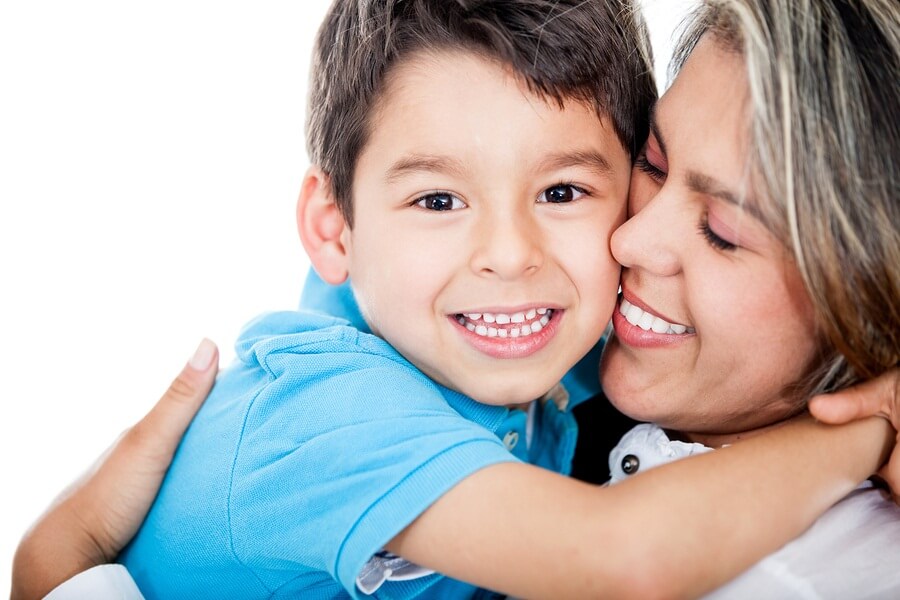 Smiling mother holding happy son