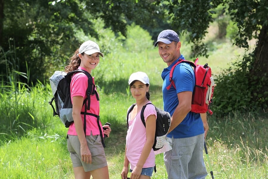 Family of four hiking along trail