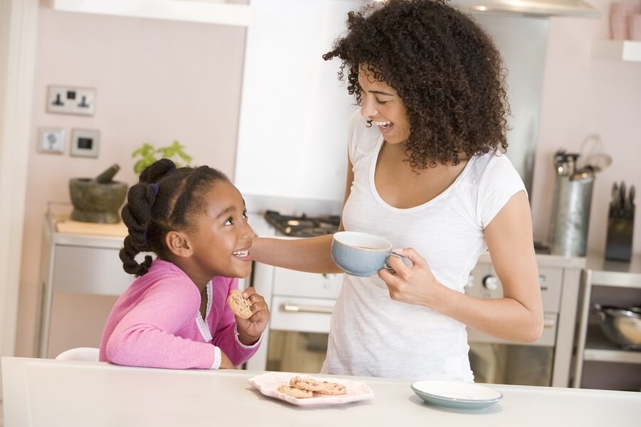 Mother and daughter baking cookies in kitchen