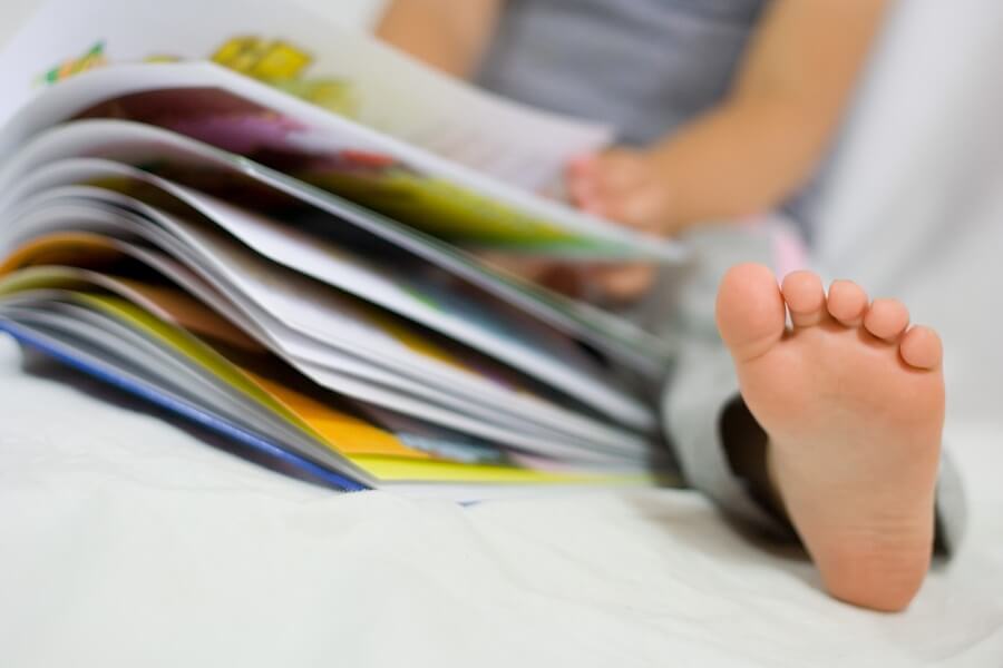 Close up of child's food while reading