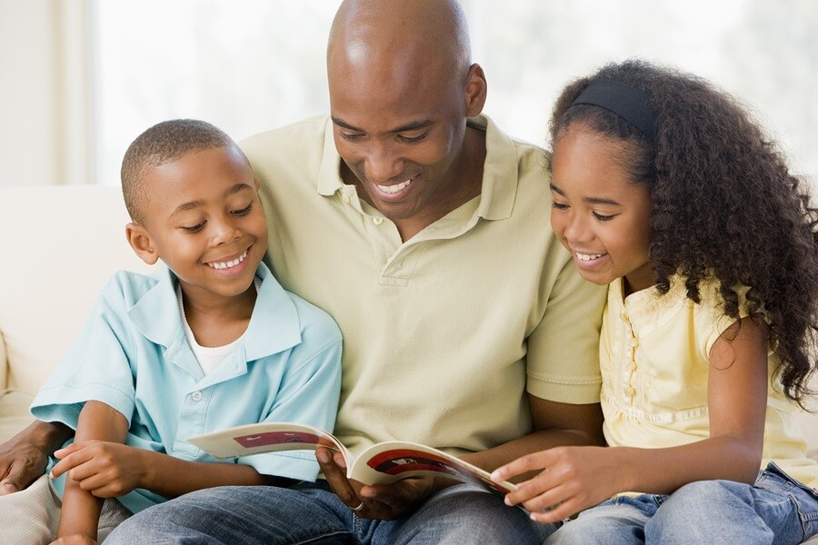 Father reading book to his children