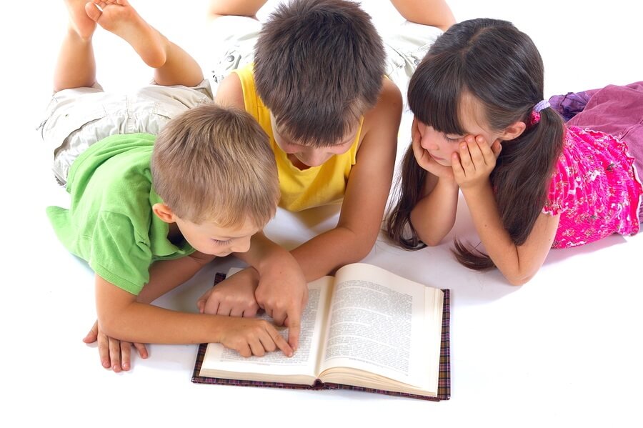 Three kids sharing one book