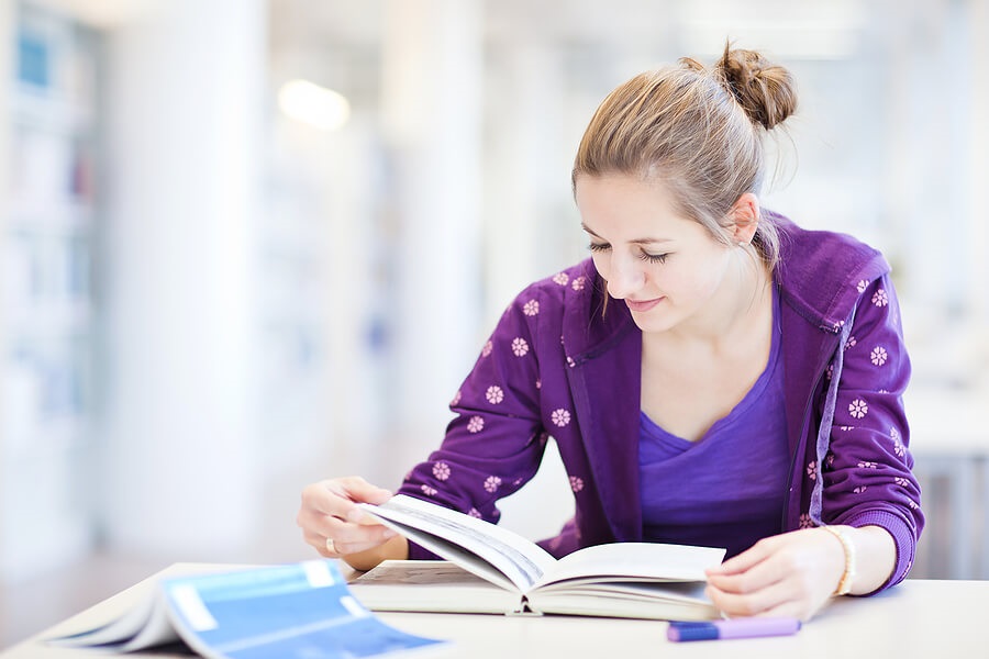 what colleges look for, female high school student studying for test