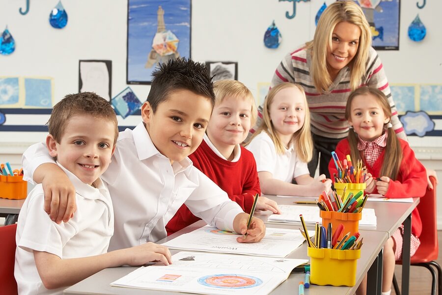 Teacher sitting at table with group of students