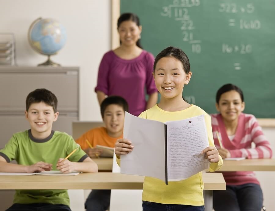 Happy student standing in fron of class