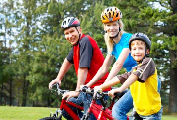 Smiling family on a summer bike ride