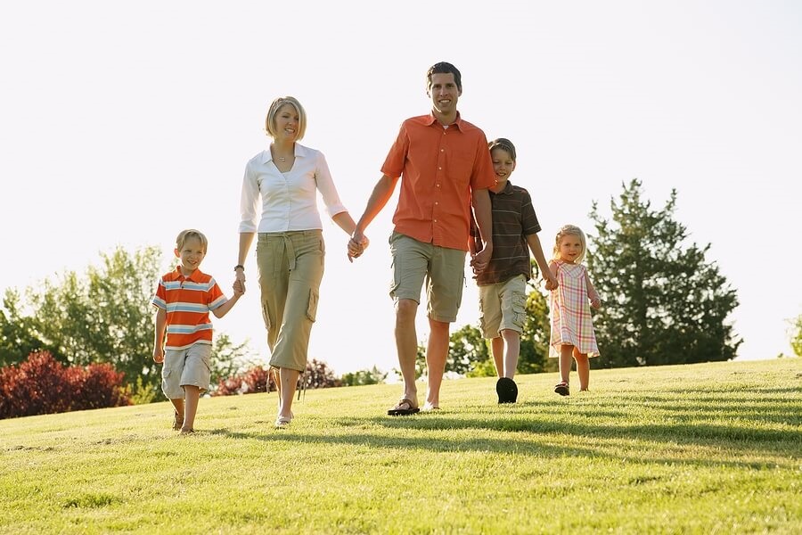 Family of four taking walk in nice weather