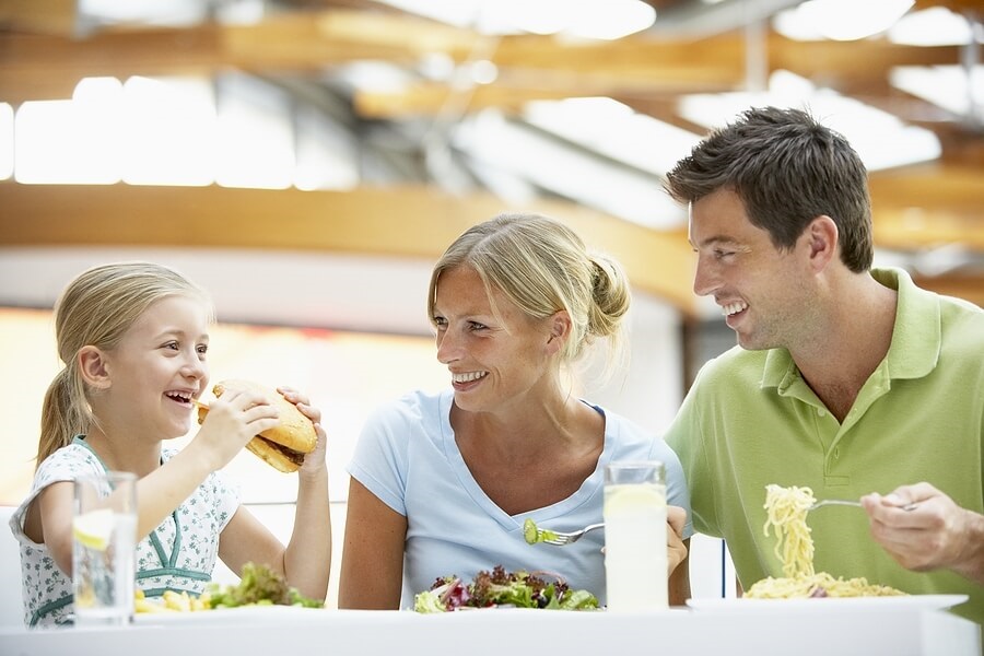 Young family eating lunch in food court