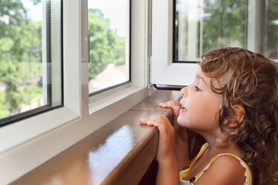 Little girl looking out the window