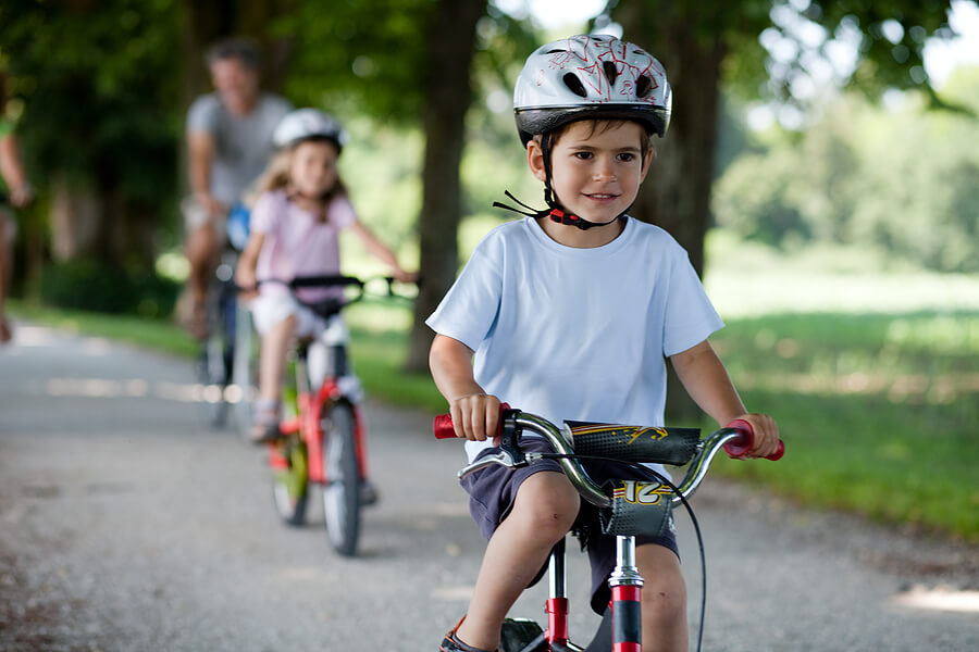 Fathers Day activities, family of four on a bike ride with helmets