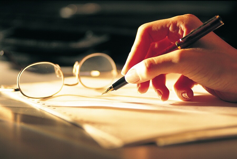 Woman writing with pen in hand